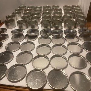 35 tins 2 oz containers with lids.  Stains  from storage.